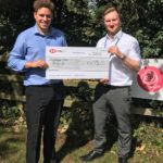 Christian handing cheque to KHH